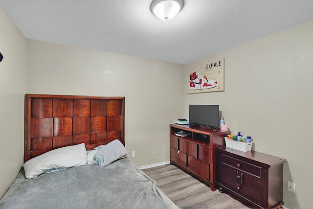 600 Saint Luke St, Terrell, TX 75160 - bedroom with light wood-style flooring and baseboards