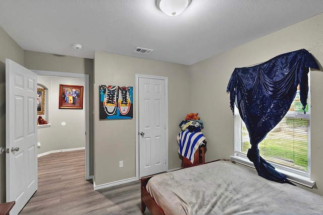 600 Saint Luke St, Terrell, TX 75160 - bedroom featuring visible vents, wood finished floors, and baseboards