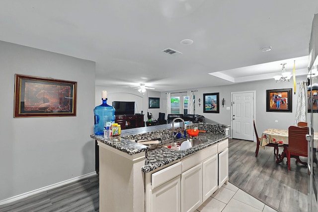600 Saint Luke St, Terrell, TX 75160 - kitchen with dark stone countertops, visible vents, a sink, and ceiling fan with notable chandelier