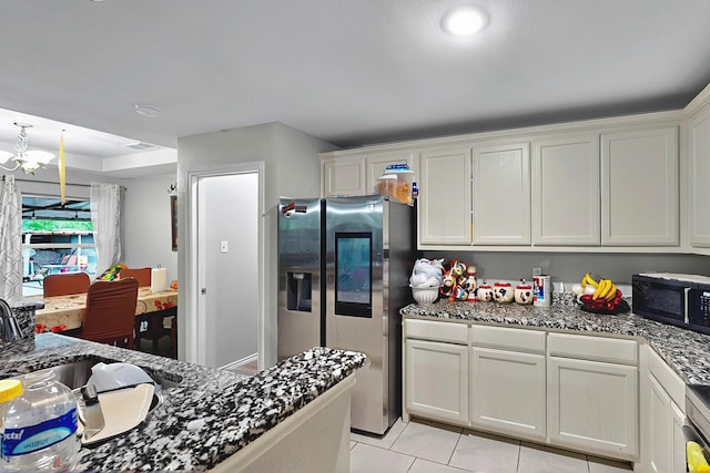 600 Saint Luke St, Terrell, TX 75160 - kitchen with light tile patterned floors, a sink, stainless steel fridge with ice dispenser, white cabinets, and black microwave