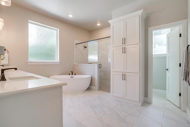 1008 Trinity Oaks Rd, Weatherford, TX 76087 - bathroom featuring a shower stall, a freestanding tub, marble look tiles, healthy amount of natural light, and recessed lighting