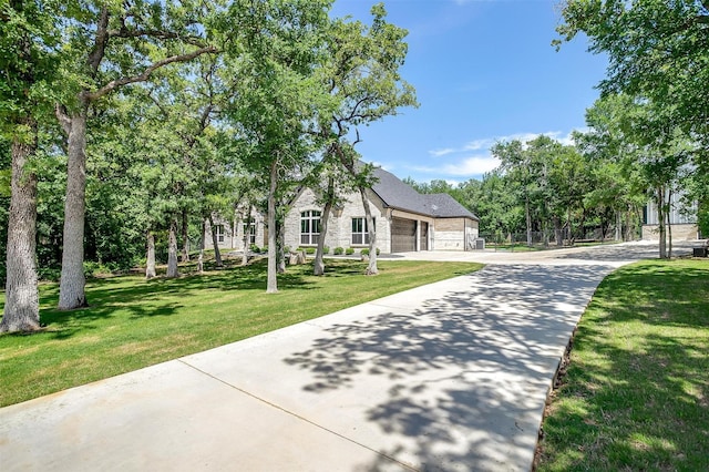 1008 Trinity Oaks Rd, Weatherford, TX 76087 - view of front of property with concrete driveway, stone siding, a front yard, and an attached garage