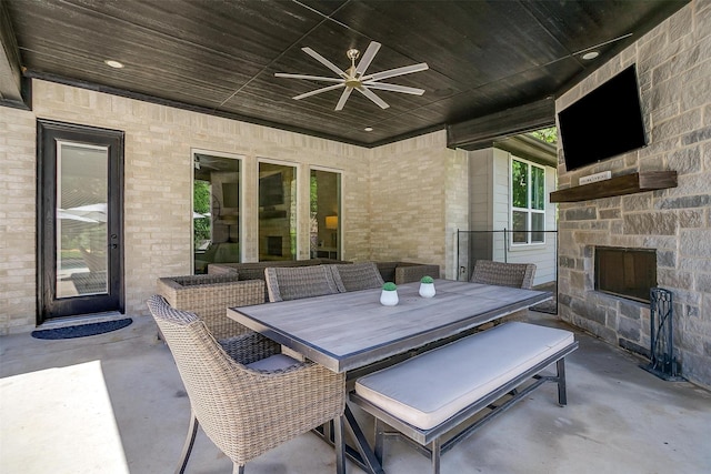 1008 Trinity Oaks Rd, Weatherford, TX 76087 - view of patio featuring an outdoor stone fireplace, ceiling fan, and outdoor dining area