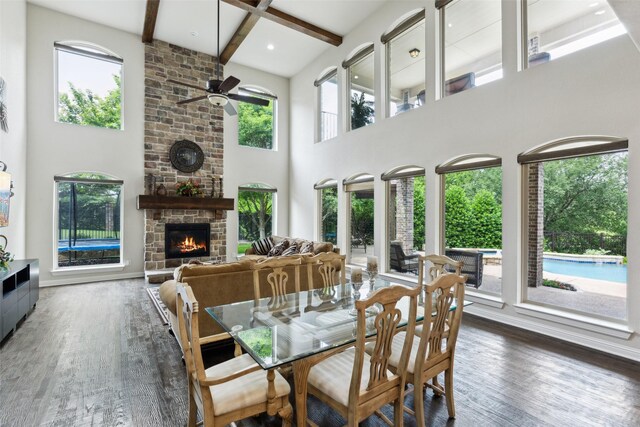 500 Denton Creek Dr, Mckinney, TX 75072 - dining area with ceiling fan, a large fireplace, healthy amount of natural light, beamed ceiling, and a towering ceiling