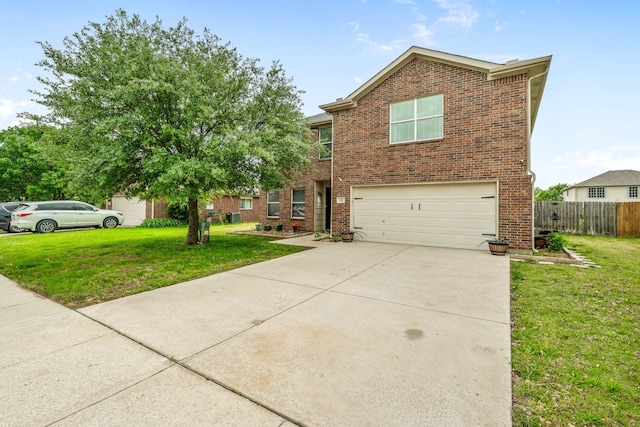 traditional-style house featuring a front lawn, brick siding, an attached garage, and fence
