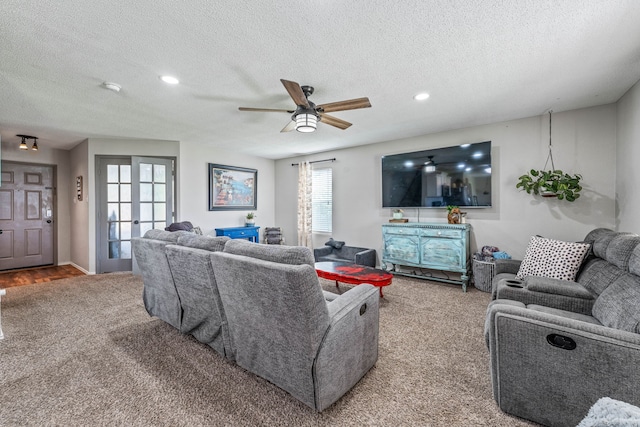 carpeted living area featuring a textured ceiling, a ceiling fan, and recessed lighting