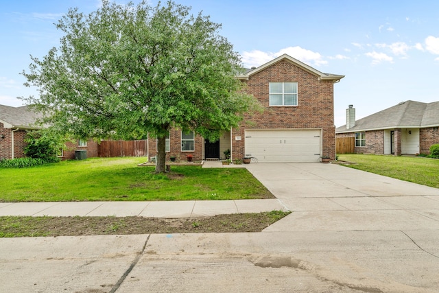 traditional home featuring a front yard, brick siding, and a garage
