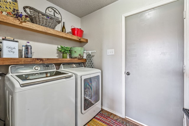 laundry room featuring a textured ceiling, laundry area, and independent washer and dryer