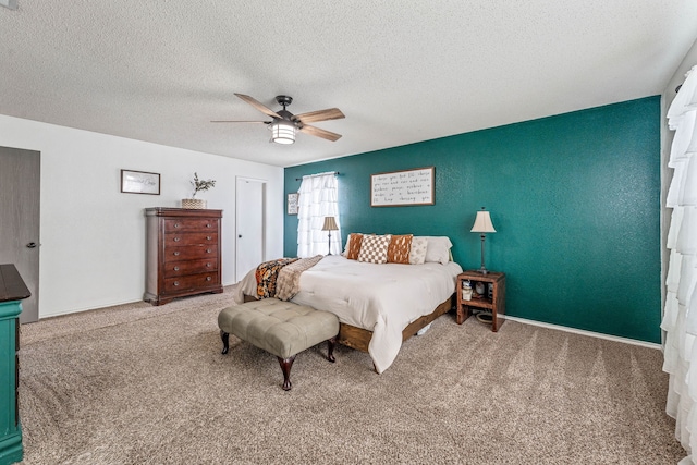 carpeted bedroom featuring a closet, a textured ceiling, and ceiling fan
