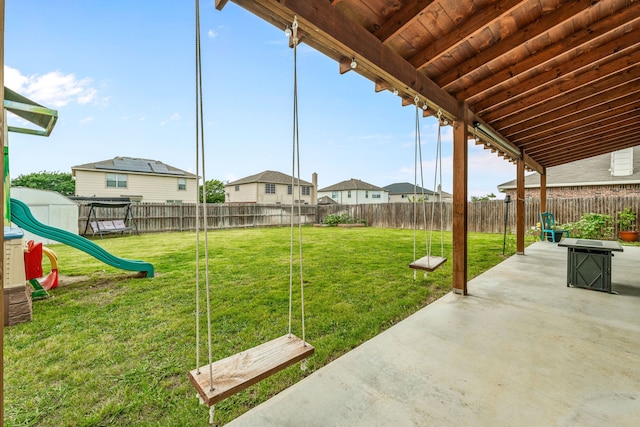 view of yard with a playground, a patio, and a fenced backyard