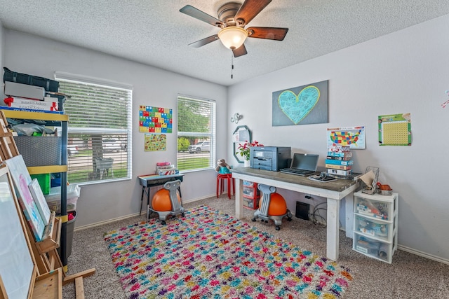 carpeted office space featuring a textured ceiling, baseboards, and a ceiling fan