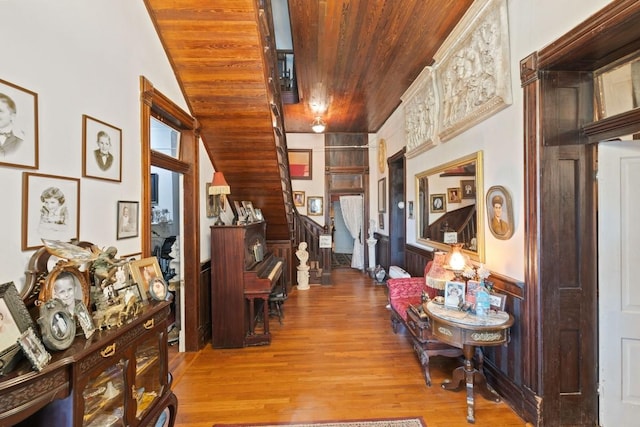 hall featuring wooden ceiling, stairs, and wood finished floors