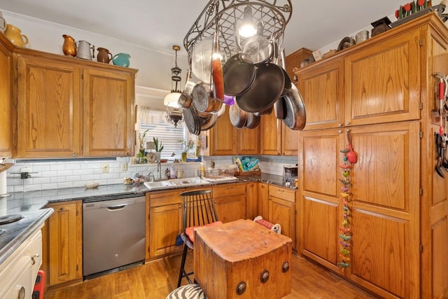 kitchen with dishwasher, brown cabinetry, and backsplash