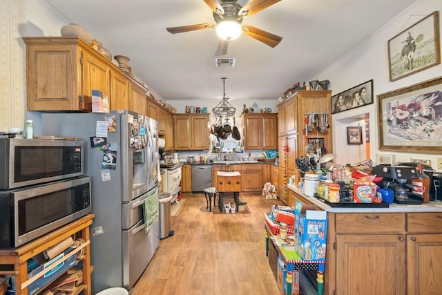 kitchen with brown cabinets, a ceiling fan, stainless steel appliances, visible vents, and light wood-style floors