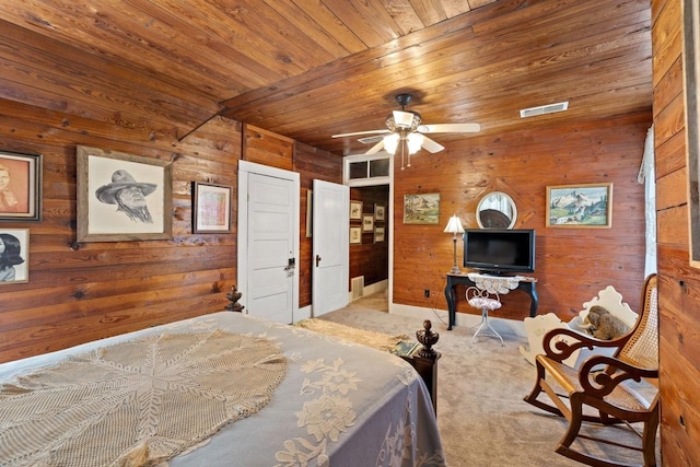 bedroom featuring wood walls, wood ceiling, carpet, and visible vents