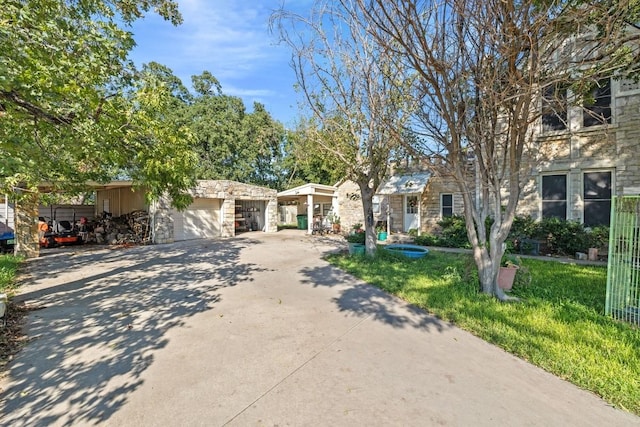 ranch-style house featuring stone siding, concrete driveway, and a garage