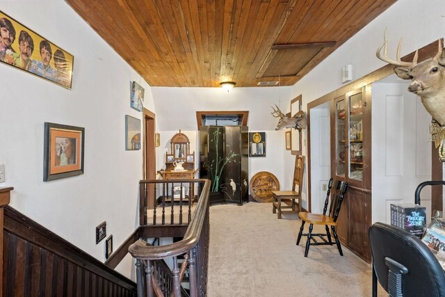 hall with carpet flooring and wooden ceiling