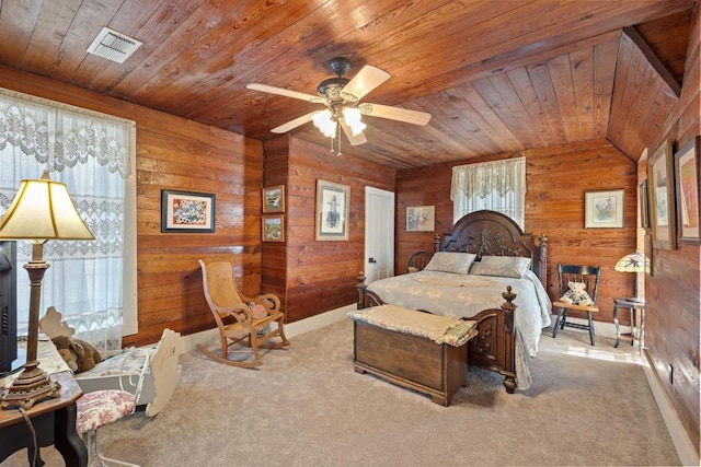 bedroom featuring a ceiling fan, carpet, visible vents, wood ceiling, and wood walls