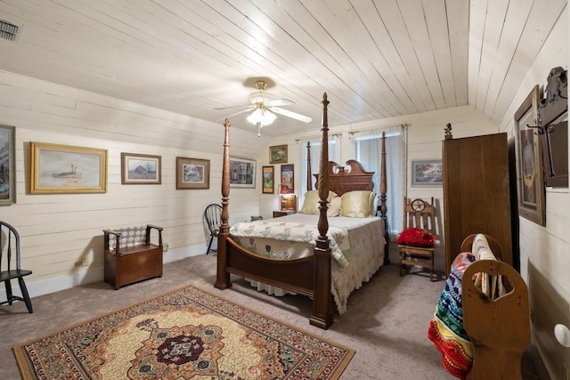 bedroom featuring light colored carpet, wood walls, wood ceiling, and visible vents