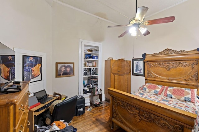 interior space featuring a ceiling fan, dark wood finished floors, and crown molding