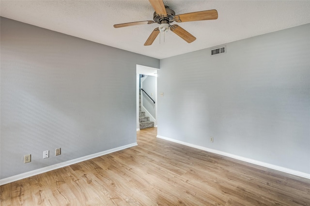 2105 Warnford Pl, Arlington, TX 76015 - spare room with wood finished floors, visible vents, baseboards, and ceiling fan