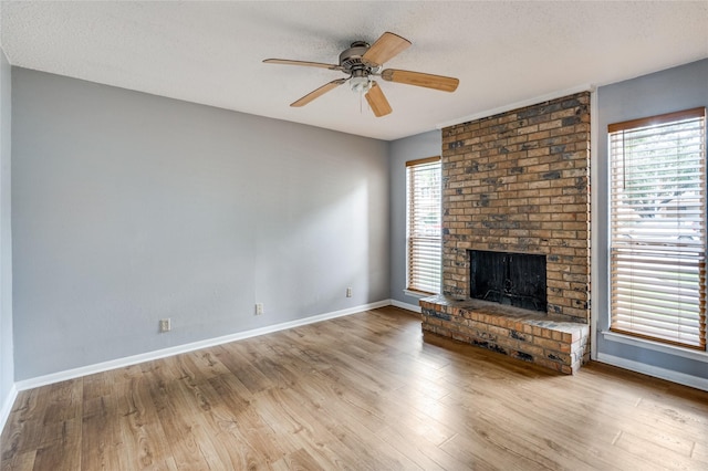 2105 Warnford Pl, Arlington, TX 76015 - unfurnished living room with baseboards, a fireplace, ceiling fan, and wood finished floors