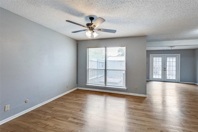 2105 Warnford Pl, Arlington, TX 76015 - empty room with a healthy amount of sunlight, french doors, and a textured ceiling
