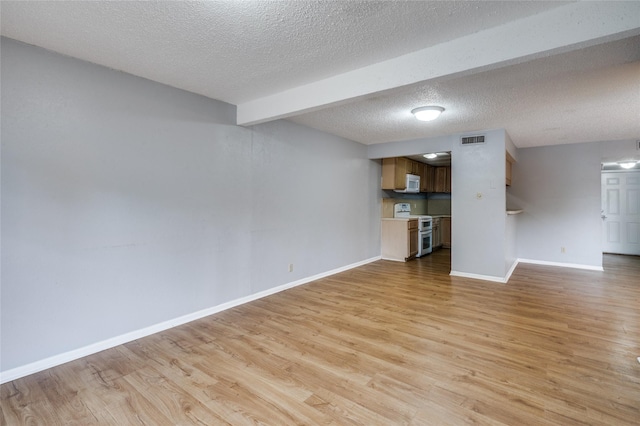 2105 Warnford Pl, Arlington, TX 76015 - unfurnished living room featuring baseboards, light wood finished floors, visible vents, and a textured ceiling