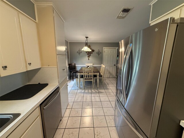 1141 Bowie St, Sulphur Springs, TX 75482 - kitchen with appliances with stainless steel finishes, light marble finish floors, light countertops, and white cabinets