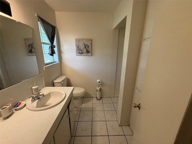 1141 Bowie St, Sulphur Springs, TX 75482 - bathroom featuring toilet, marble finish flooring, and vanity