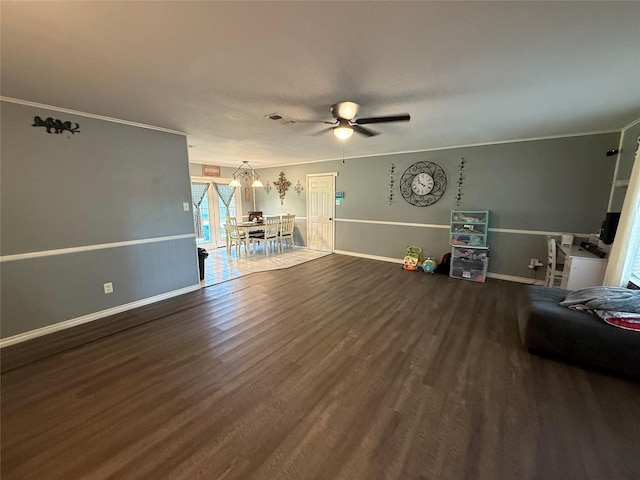 1141 Bowie St, Sulphur Springs, TX 75482 - living area featuring wood finished floors, ceiling fan, crown molding, and baseboards