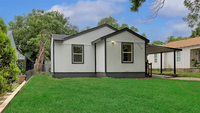 rear view of house with a yard and fence