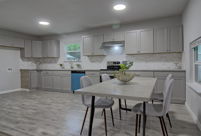 kitchen with under cabinet range hood, dishwasher, stainless steel electric range oven, and gray cabinetry