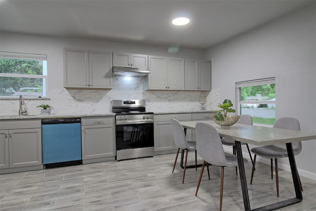 kitchen with dishwashing machine, stainless steel range with electric stovetop, a sink, under cabinet range hood, and gray cabinetry