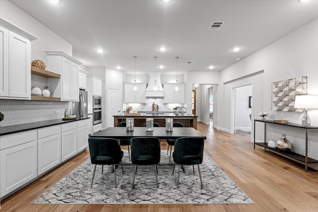 913 Beall St, Denton, TX 76207 - dining area with baseboards, recessed lighting, light wood-style floors, and visible vents