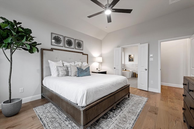 913 Beall St, Denton, TX 76207 - bedroom featuring lofted ceiling, ensuite bathroom, baseboards, and wood finished floors
