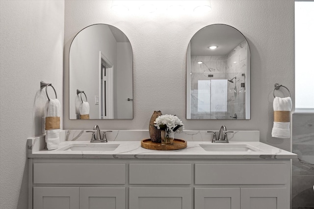 913 Beall St, Denton, TX 76207 - full bathroom featuring double vanity, a stall shower, and a sink