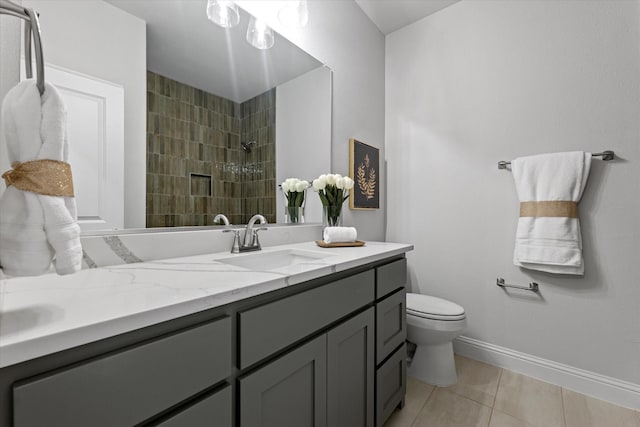 913 Beall St, Denton, TX 76207 - bathroom featuring toilet, vanity, tile patterned flooring, baseboards, and a tile shower