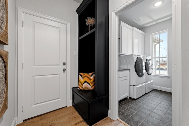 913 Beall St, Denton, TX 76207 - washroom featuring cabinet space, visible vents, tile patterned floors, washing machine and clothes dryer, and baseboards