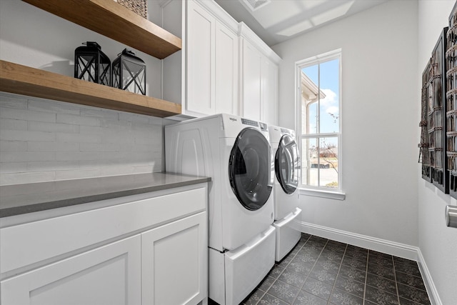 913 Beall St, Denton, TX 76207 - clothes washing area featuring baseboards, dark tile patterned flooring, separate washer and dryer, and cabinet space