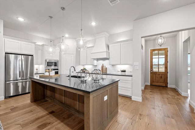 913 Beall St, Denton, TX 76207 - kitchen featuring baseboards, a sink, premium range hood, dark countertops, and appliances with stainless steel finishes