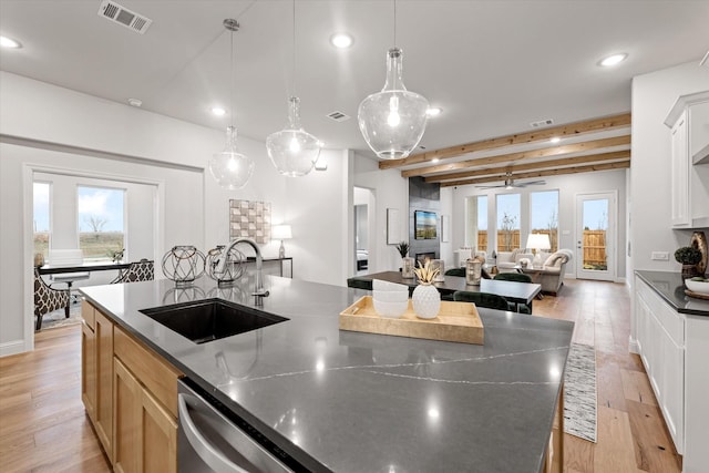 913 Beall St, Denton, TX 76207 - kitchen featuring a healthy amount of sunlight, visible vents, open floor plan, and a sink