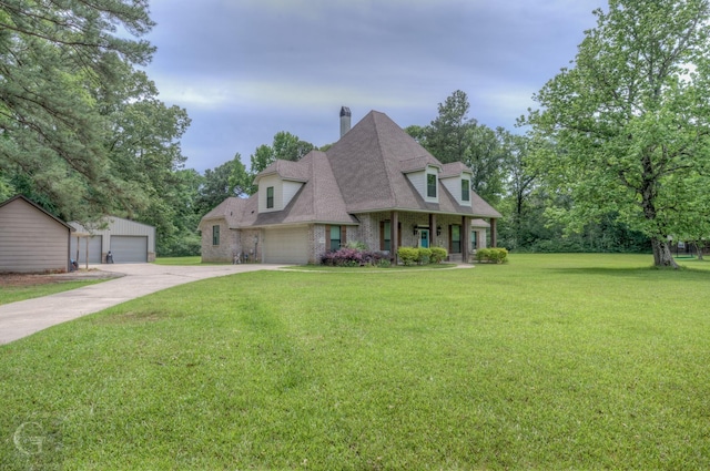 view of front of home featuring a chimney, an outdoor structure, a porch, roof with shingles, and a front lawn