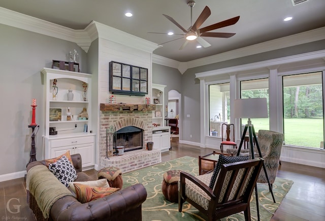 living area featuring baseboards, a ceiling fan, a brick fireplace, and recessed lighting