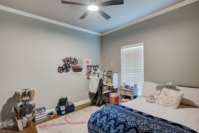 bedroom featuring crown molding, baseboards, ceiling fan, and wood finished floors