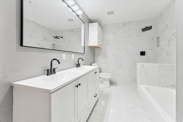 bathroom with toilet, marble finish floor, double vanity, and a sink