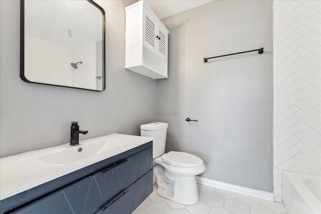 full bathroom featuring vanity, toilet, baseboards, and tile patterned flooring