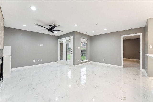 unfurnished living room featuring marble finish floor, baseboards, ceiling fan, and recessed lighting