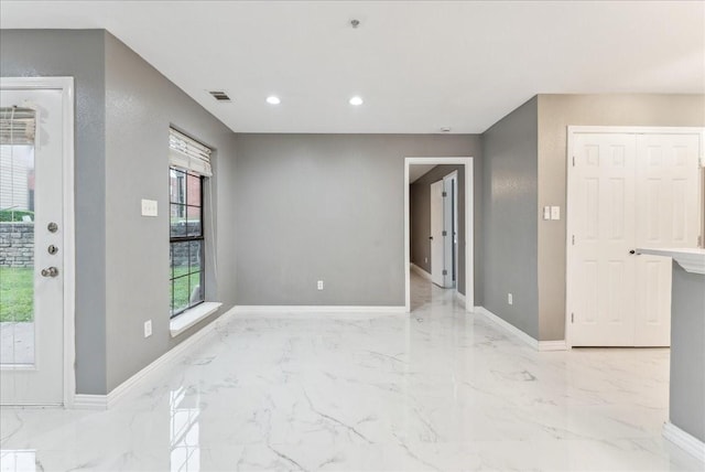 spare room featuring baseboards, recessed lighting, marble finish floor, and visible vents