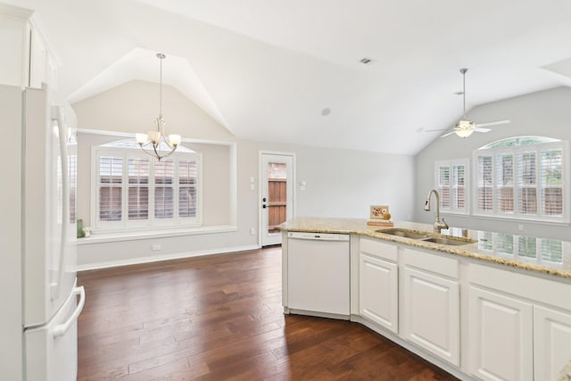 4118 Armistice Dr, Frisco, TX 75034 - kitchen with a sink, white appliances, dark wood finished floors, vaulted ceiling, and white cabinetry